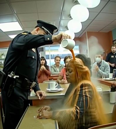 Racist Cop Pours Coffee On Quiet Middle Aged Black Woman Only To Fall To His