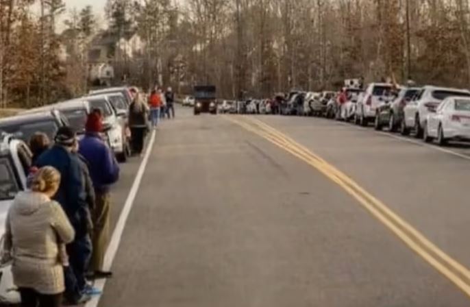 UPS driver is obviously moved to tears after learning why cars were lined up and down the road